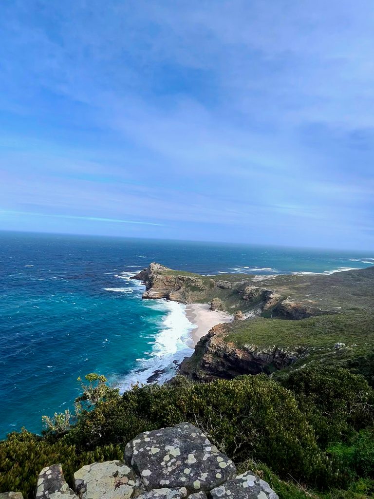 Rugged coastline with turquoise ocean, cliffs and a sandy beach