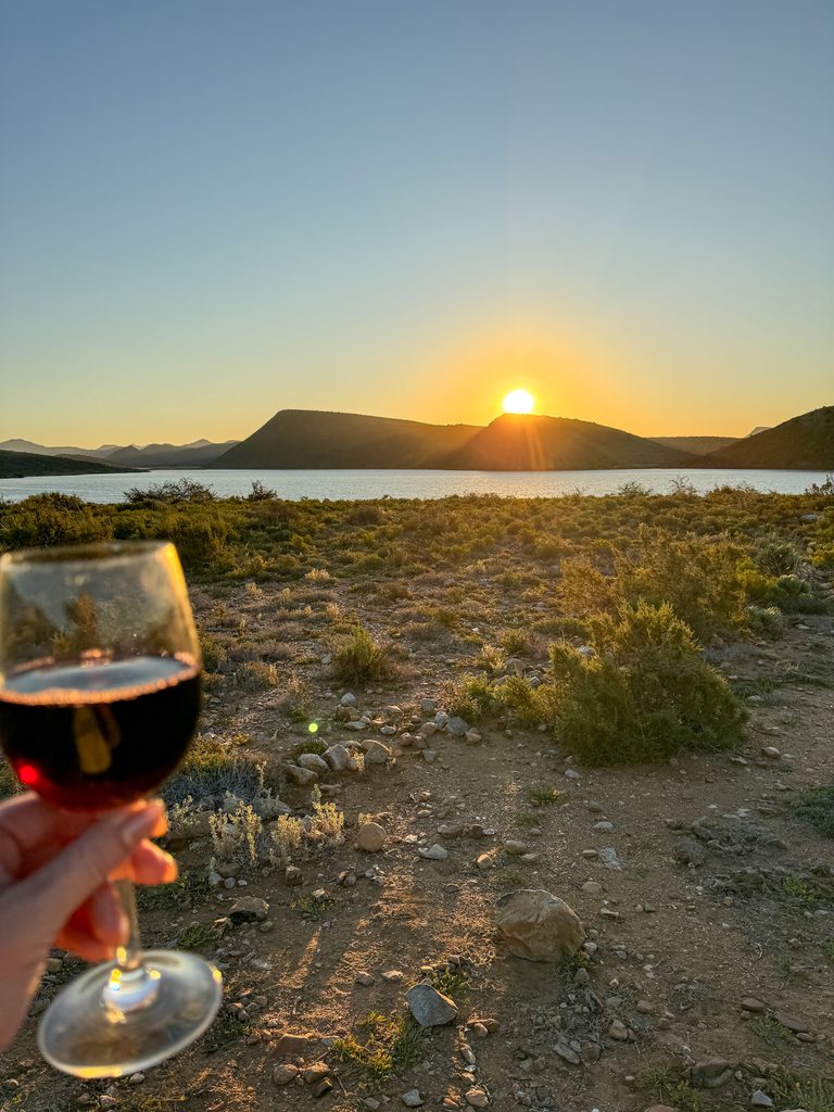 Sunset and wine overlooking the South African safari landscape