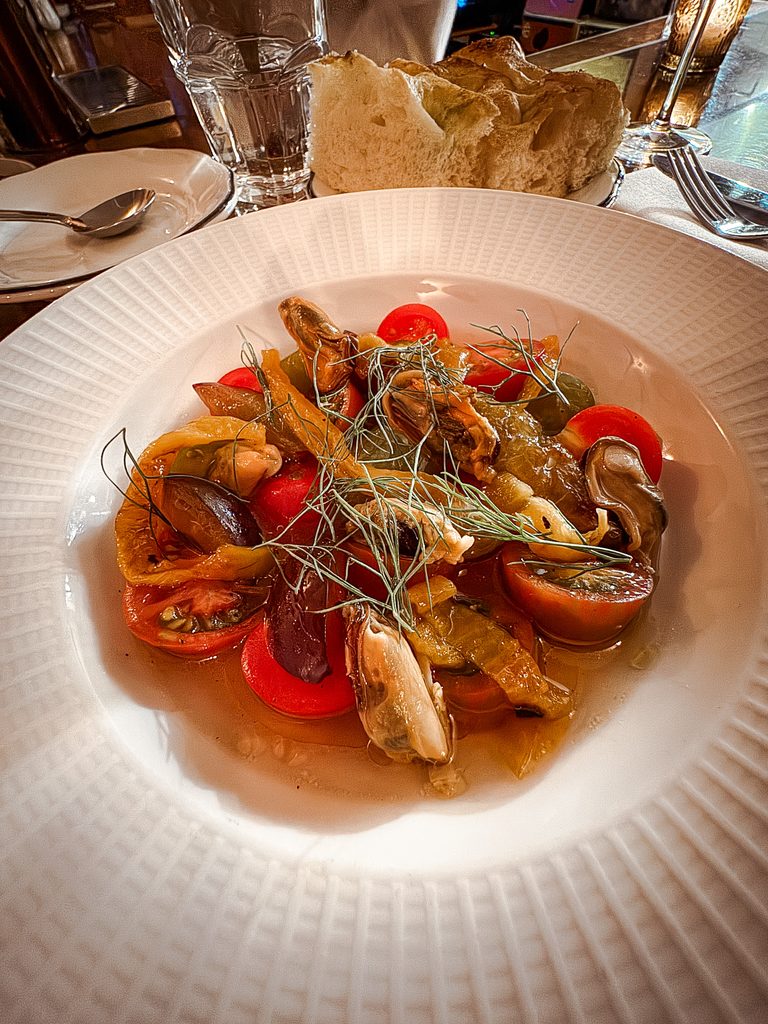Locally inspired dish with tomatoes and mussels at a restaurant in Québec City