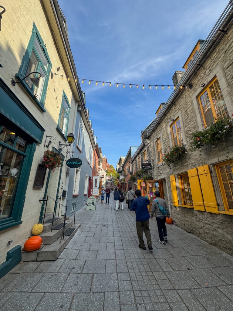 Cobblestone street lined with historic buildings and shops in Old Québec City